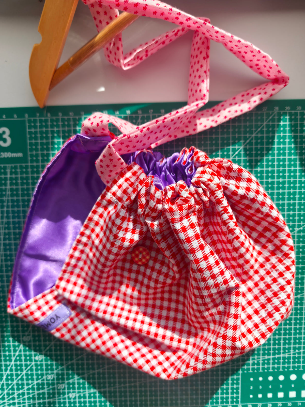 Scrub cap, cotton fabric with a satin inner. Has buttons for the pulls of  your mask to relieve  pressure from your ears