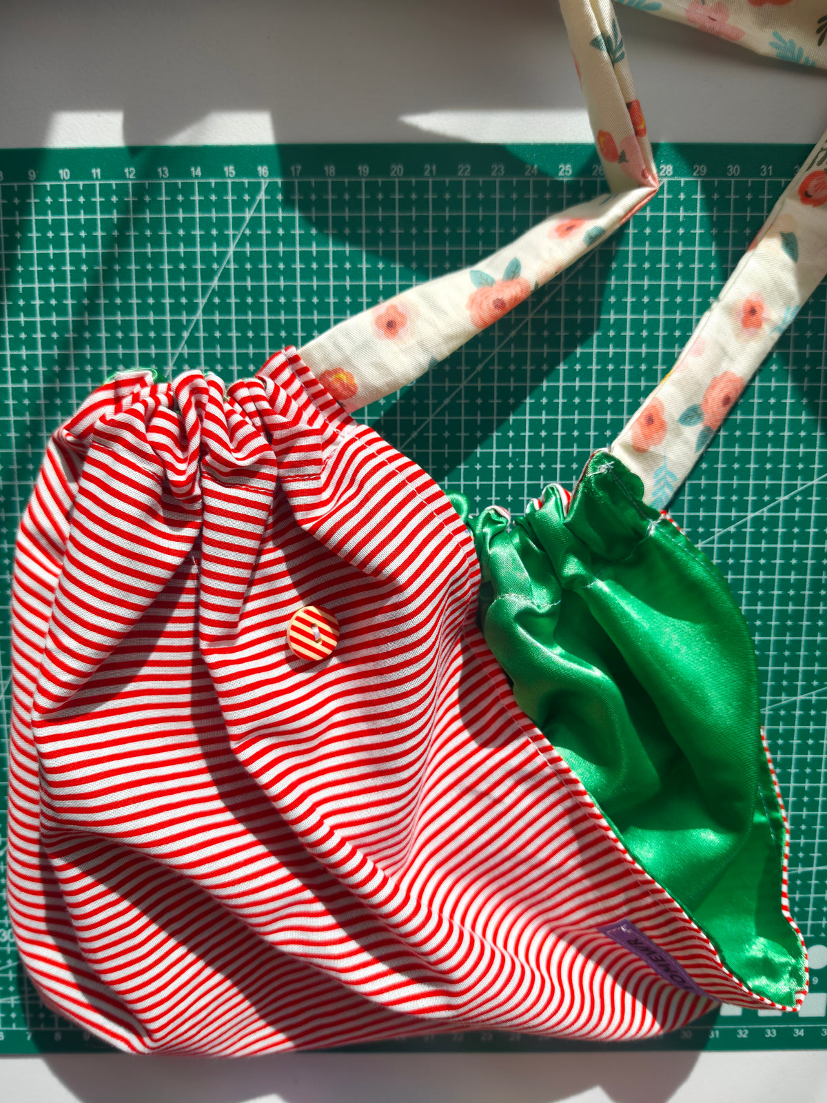 Scrub cap, cotton fabric with a satin inner. Has buttons for the pulls of  your mask to relieve  pressure from your ears