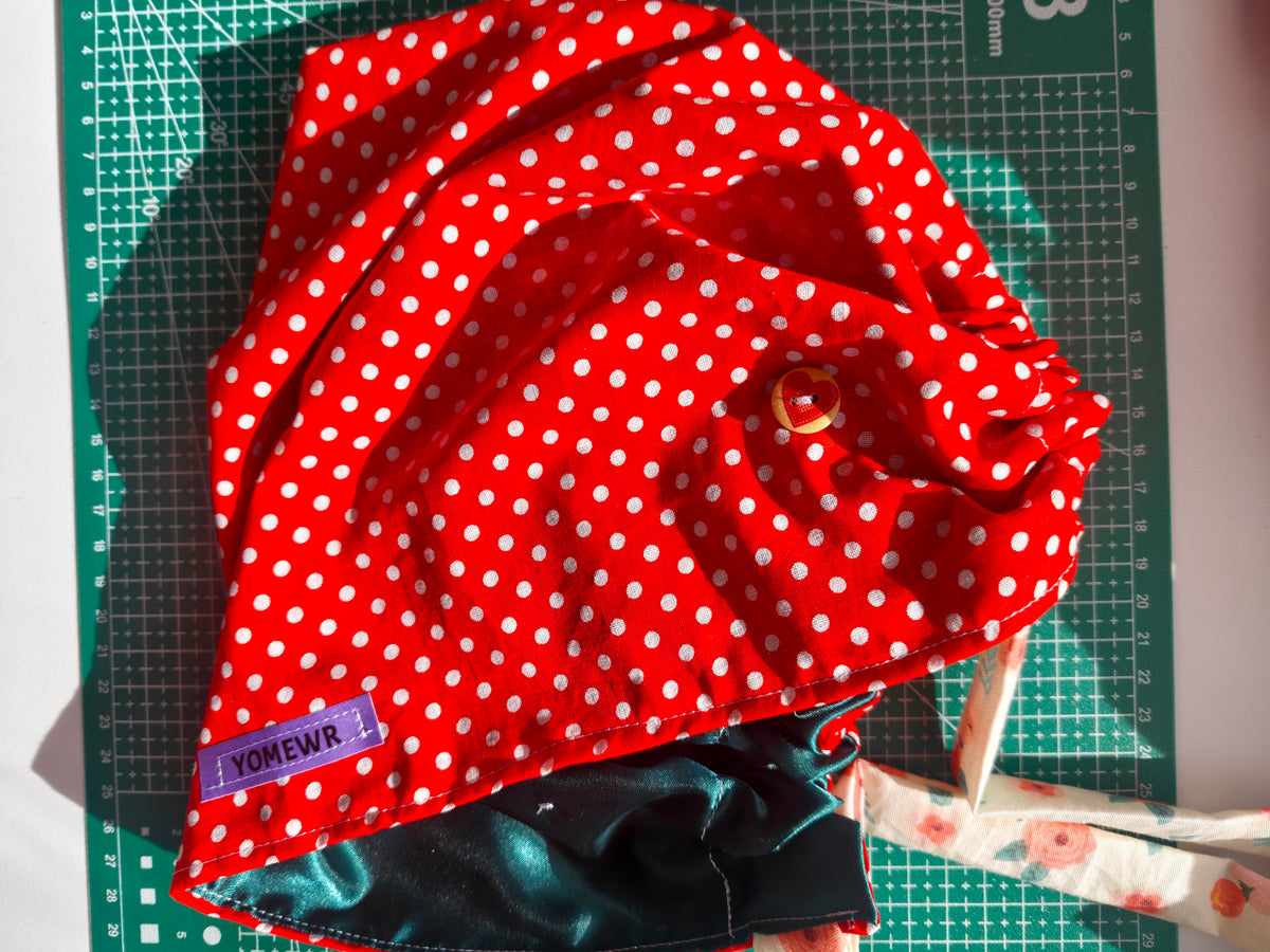 Scrub cap, cotton fabric with a satin inner. Has buttons for the pulls of  your mask to relieve  pressure from your ears