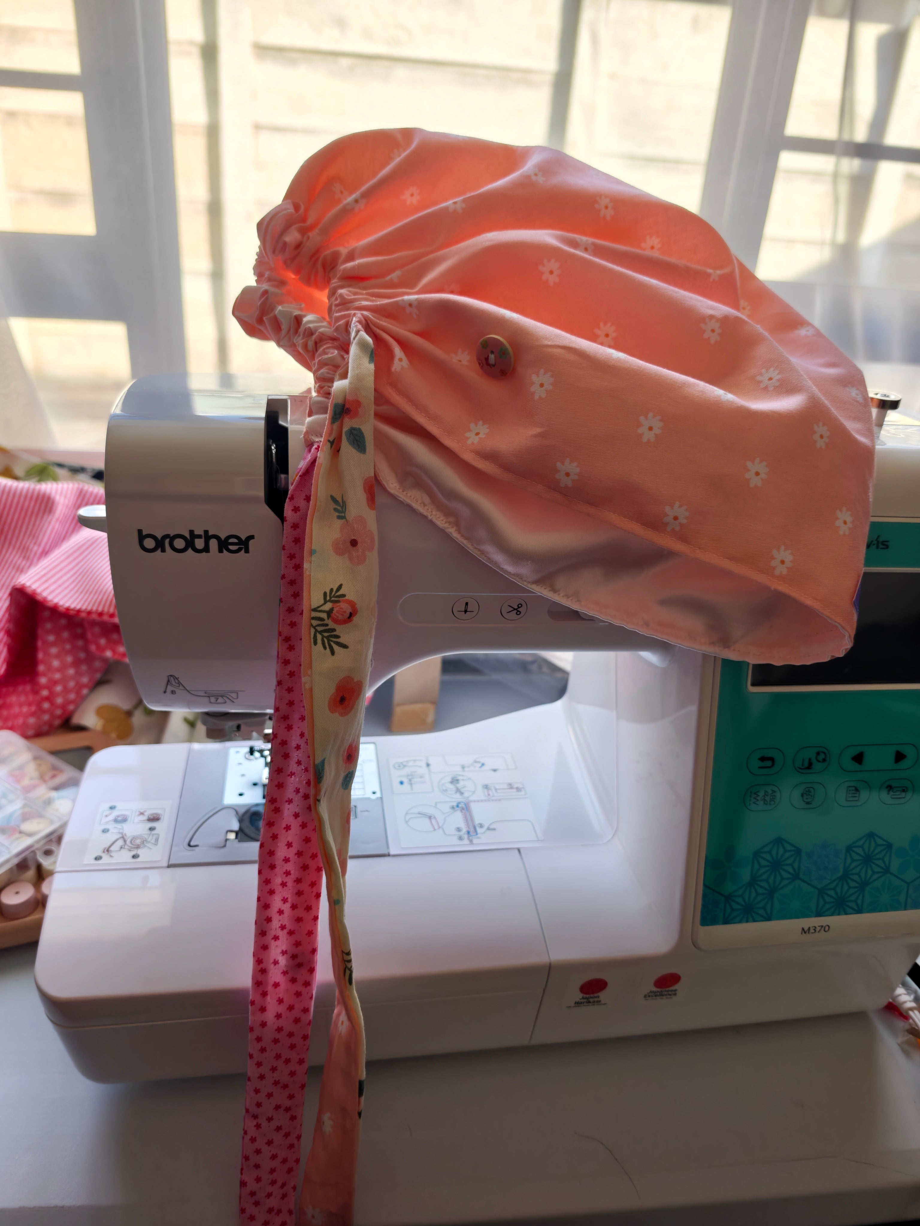 Scrub cap, cotton fabric with a satin inner. Has buttons for the pulls of  your mask to relieve  pressure from your ears